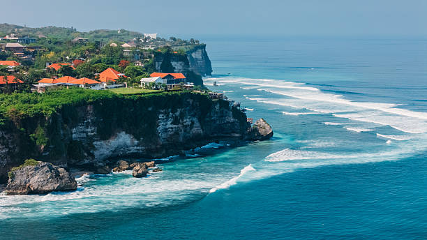 Uluwatu coastline with cliffs, rock and surfing waves in Bali. Scenic landscape in Indonesia